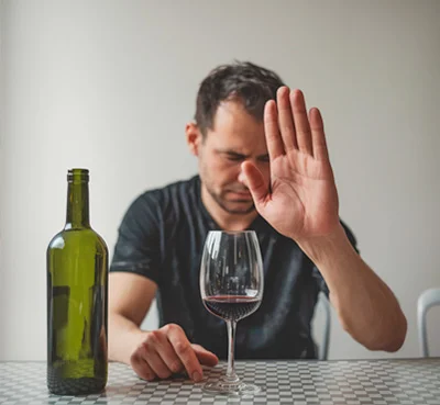 Мужчина за столом показывает жест стоп